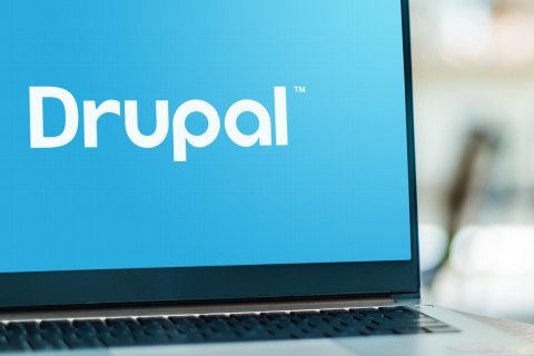 Laptop with Drupal written in white on a blue background