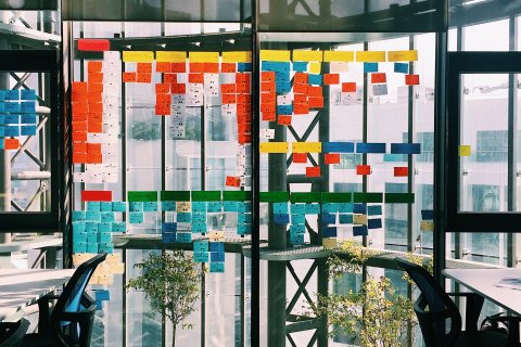 Modern office with post-it notes stuck on a glass wall