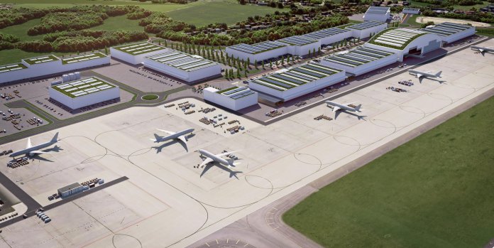 Vue aérienne d'un aéroport moderne avec terminal et avions sur le tarmac.