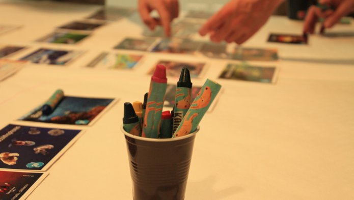 Photo of a pot of chalk with the climate fresco in the background