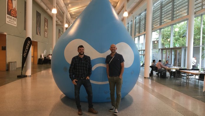 Benoit and Nicolas in front of the giant drupal mascot in 2014