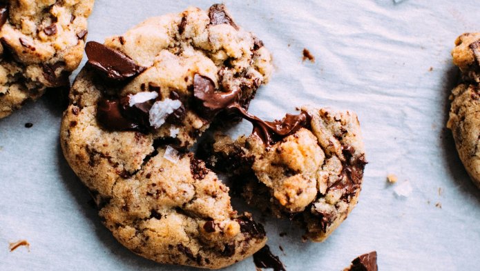 Photo d'un cookie cassé aux pépites de chocolat sur une nappe